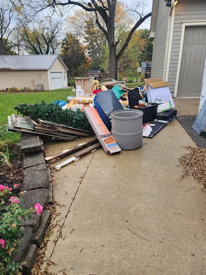 Dumpster being loaded with debris for Roofing Dumpster Rental in Silver Creek